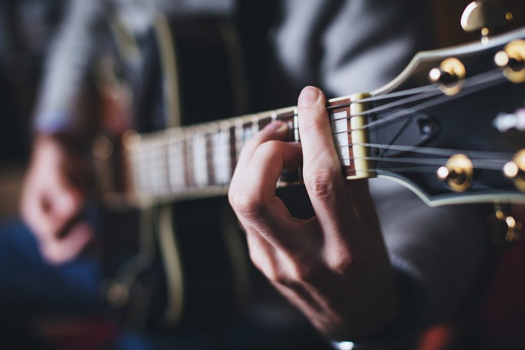 Chord - Picture of a Guitarist Playing a Barre Chord - How Common are Mistakes While Practicing and Playing Guitar- Guitar Tuner Online (Standard Guitar Tuning)