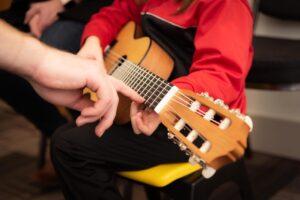 Can I Become a Music Teacher if I Have Special Needs - Teacher Teaching Young Guitar Student - What’s the Best Lesson You’ve Had with Your Music Teacher?