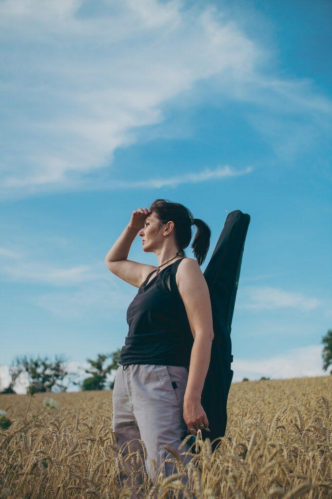 How to Choose the Best Guitar Case for You - Woman with Gig Bag
