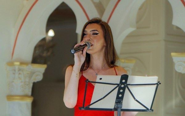 How Do I Match My Pitch to Another Singer - Woman with Mic - Singing Vocal Exercises - What Does Intonation Mean and Why Is It Essential in Music