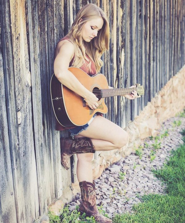 How to Play the Frustrating B Minor Guitar Chord - Woman Playing Guitar