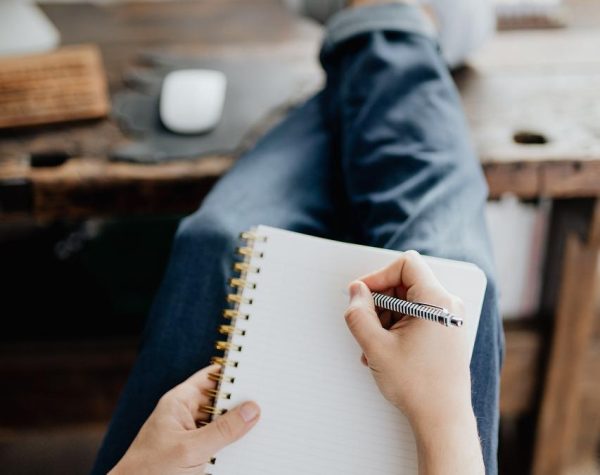 What Is an Adverb - Learn About Amazing, Adaptable Adverbs - Man Writing - What's Assonance and What’s the Best Way to Use it in Writing? - What Is Satire and How to Write It