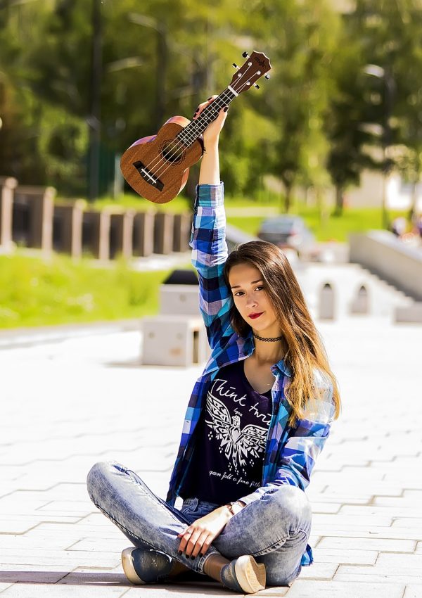 Tune your ukulele like a Hawaiian - girl and ukulele - What Are Some Signs of a Twice Exceptional (2E) Child - Tune the Ukulele with a Free Online Tuner