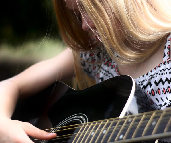 ASD - Girl Playing a Guitar - Once Sheet Music is All Digital, Why Not Always Colour-Code Notes - What Do You Think of the Chord Buddy for Special Needs Guitarists