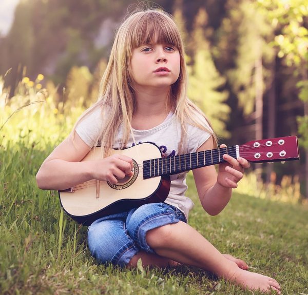 color coded note head extenders - girl playing guitar -Tips for Teaching an Autistic Child the Guitar