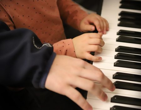 playing piano with color coded left hand notes - piano lesson - Music Therapy vs Music Lessons