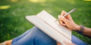 Where Do I Get Inspiration for My Lyrics - Lyrics - a woman writing on a note pad - Learn Rhyme and Reason in Songwriting.jpg
